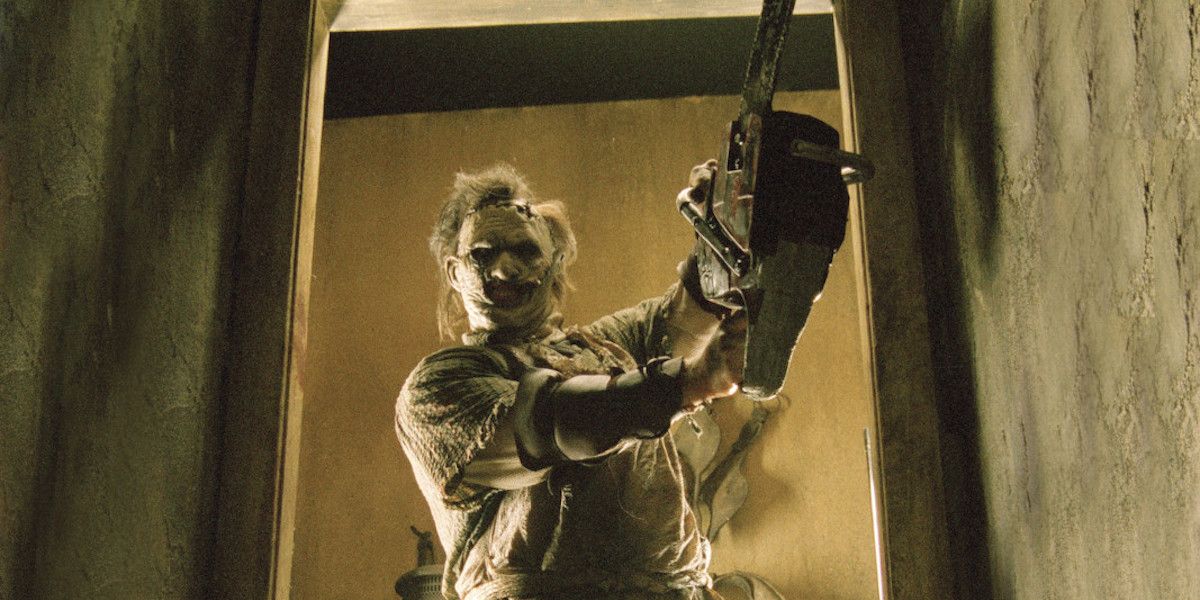 Leatherface raising a chainsaw in a doorway in 2003's 'The Texas Chainsaw Massacre '
