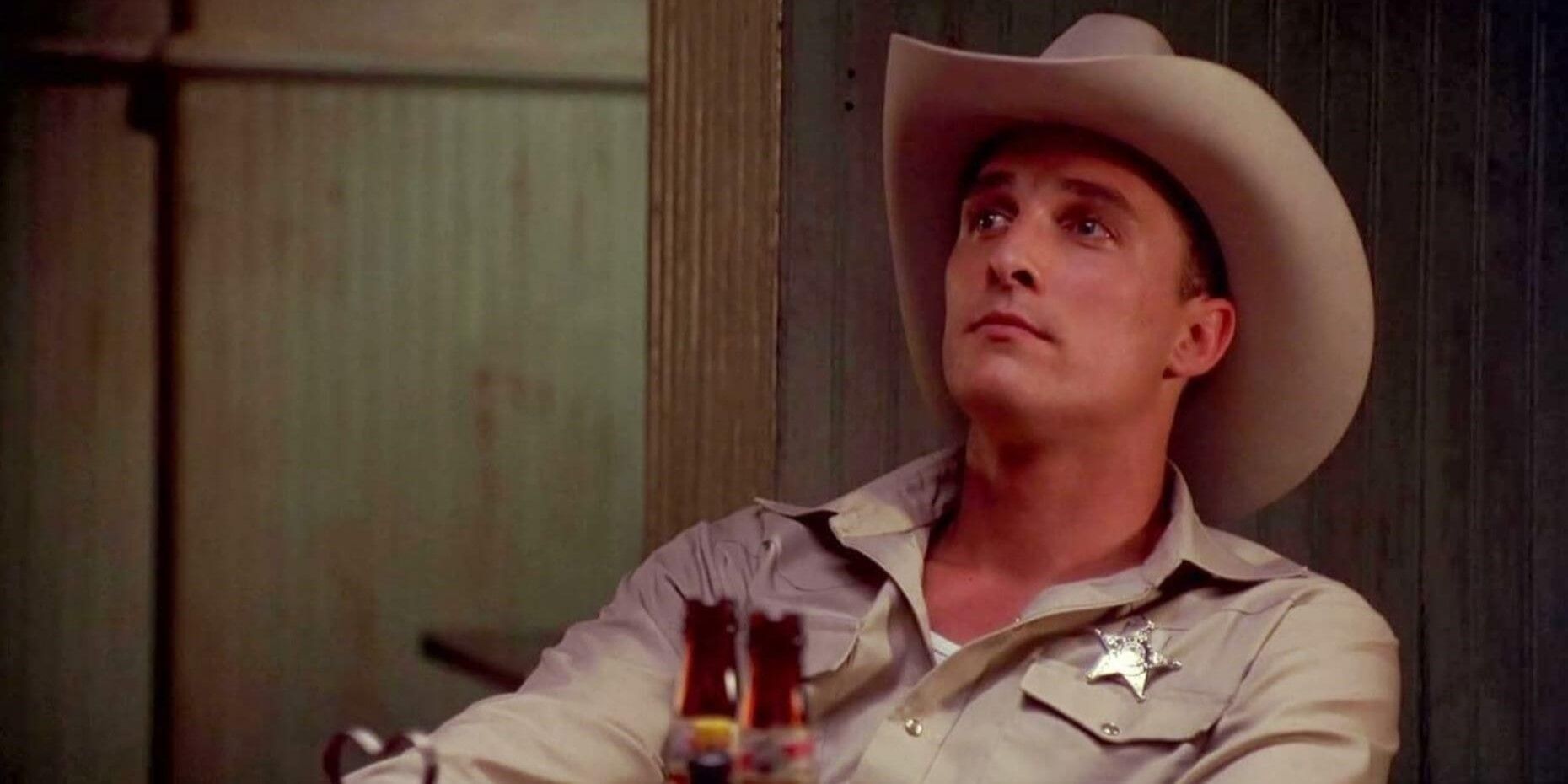 Buddy Deeds (Matthew McConaughey) in uniform sitting by two beers in Lone Star.