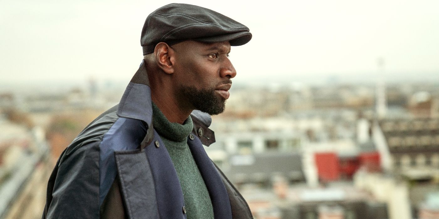 Omar Sy as Assane Diop, looking out over the city in Lupin