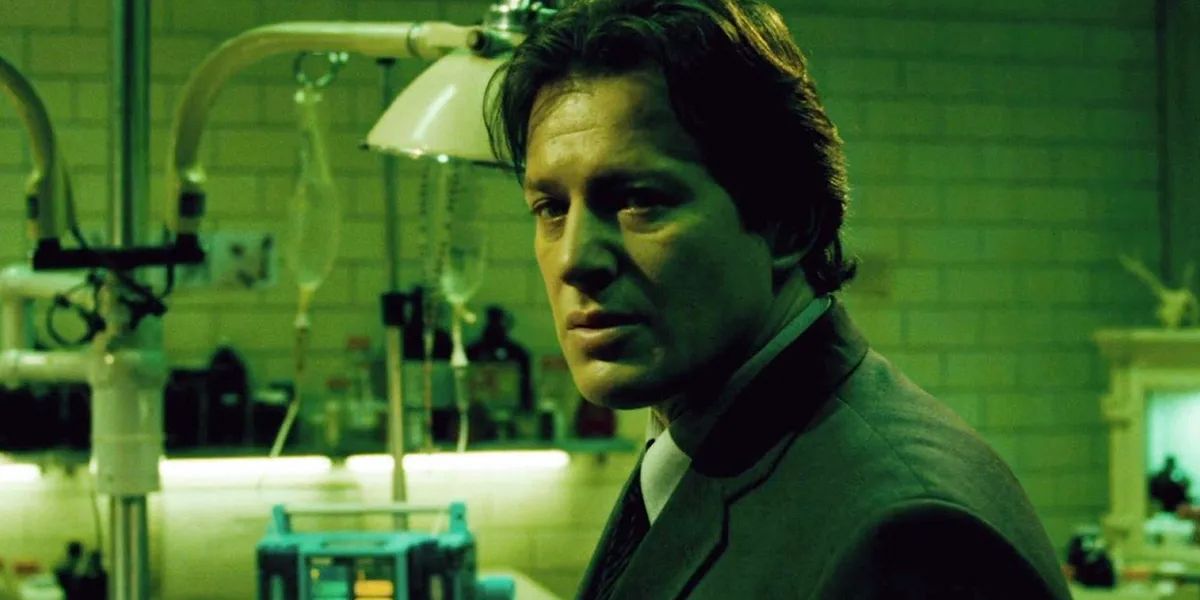 Costas Mandylor as Detective Hoffman standing in a lab in Saw III