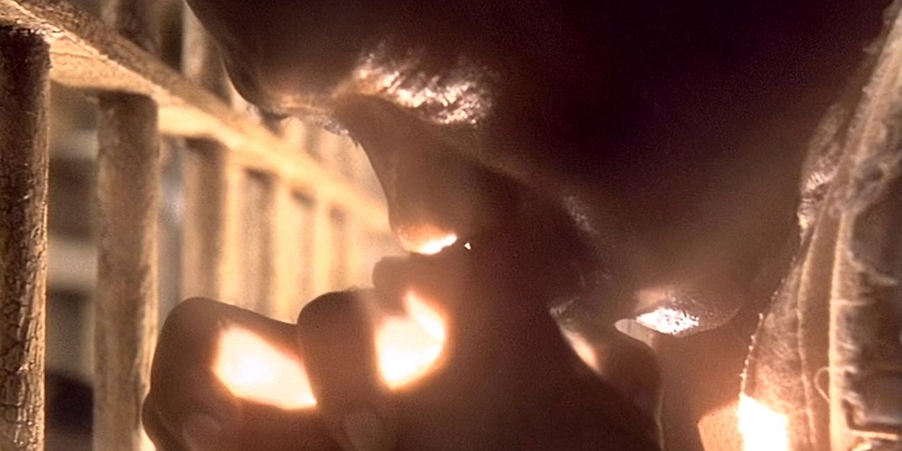 John Coffey emanating light from his hands in his jail cell