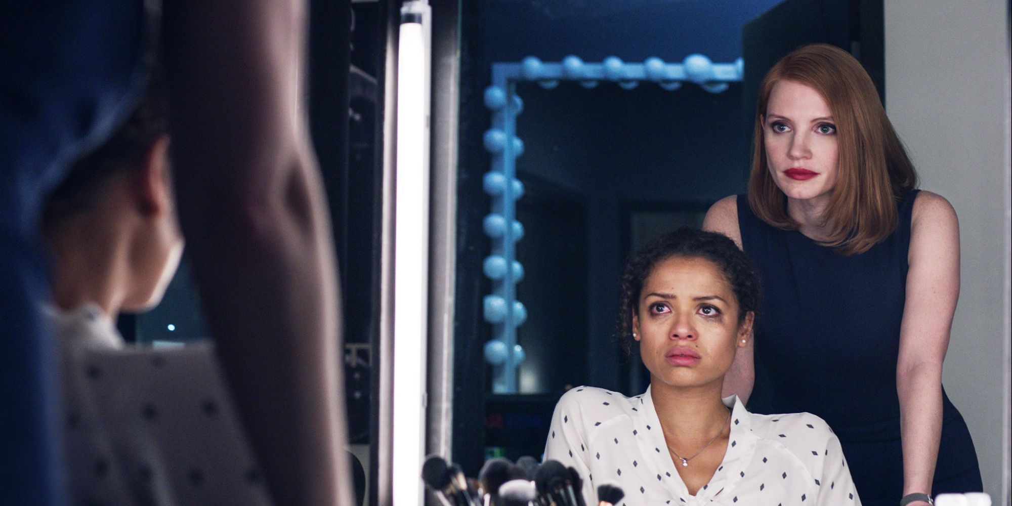 Gugu Mbatha-Raw and Jessica Chastain, having a stern conversations while looking at each other in the mirror