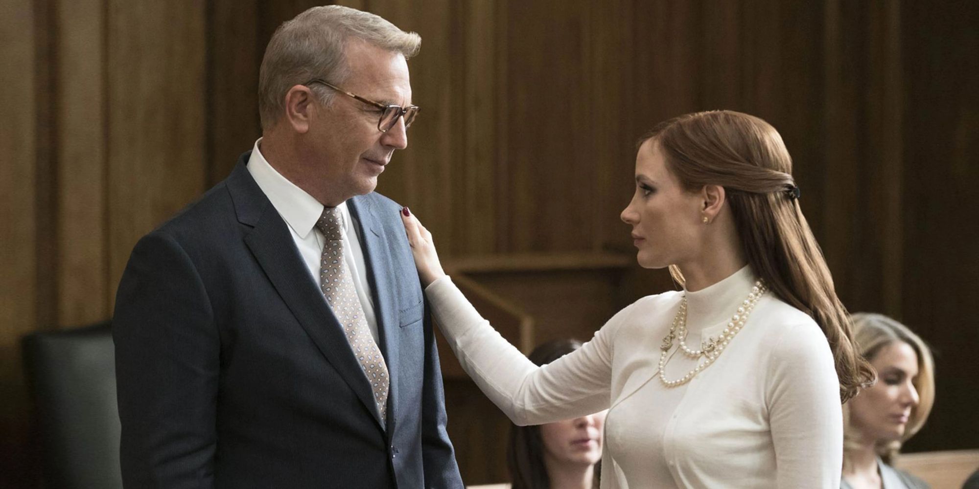 Kevin Costner and Jessica Chastain as Larry and Molly Bloom in Molly's game, with Molly touching Larry's shoulder solemenly.