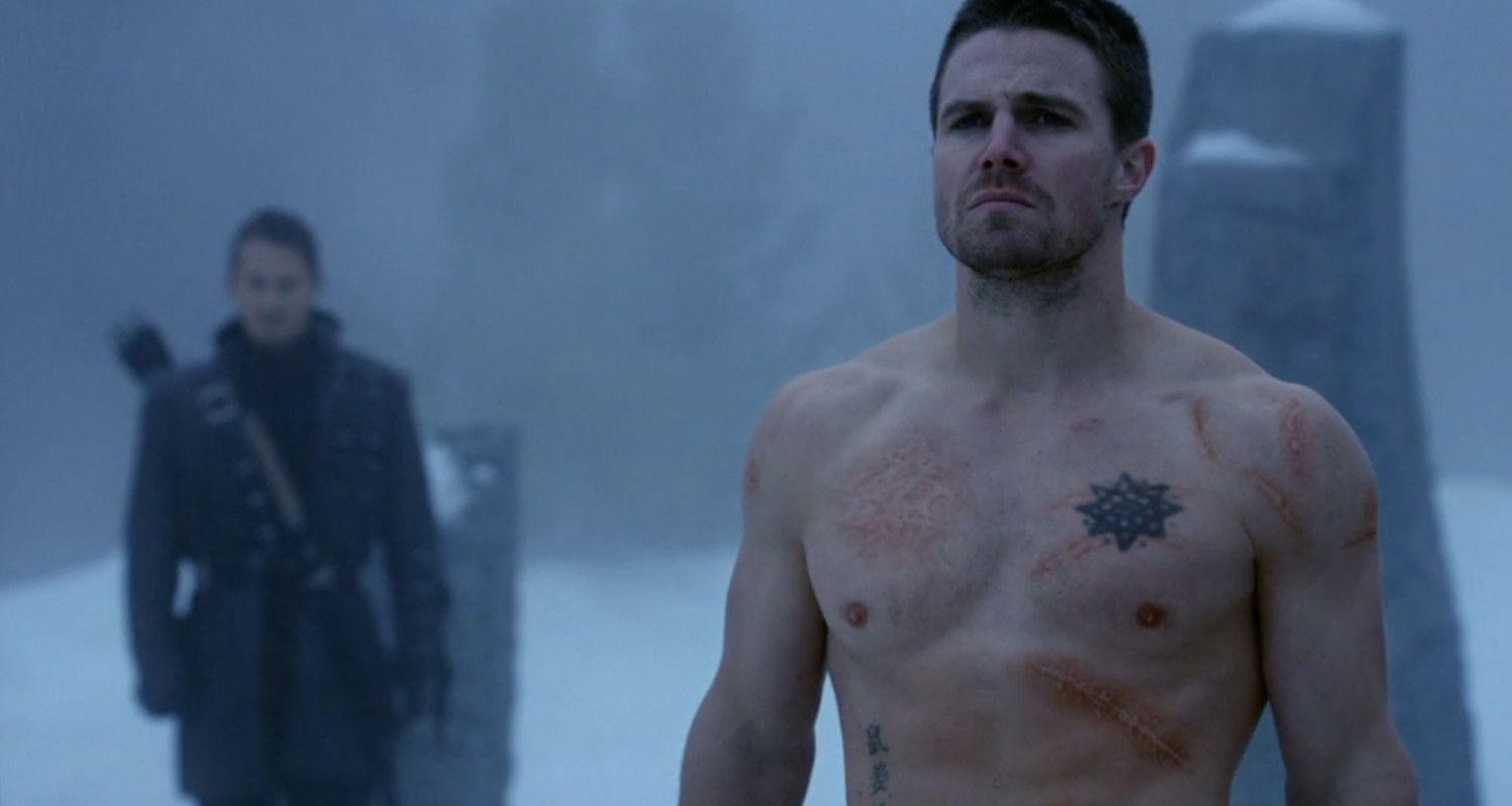 Oliver Queen standing on a mountain top in Arrow