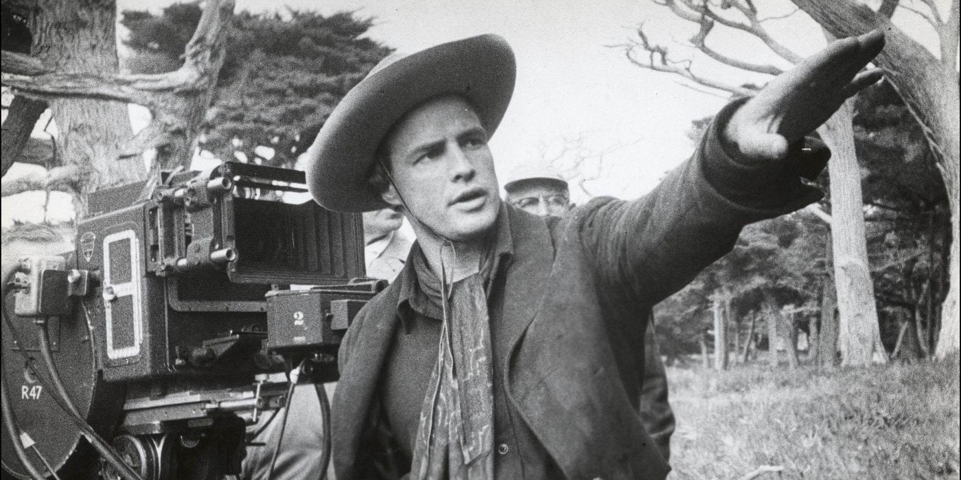 A black and white still of Marlon Brando directing on the set of One-Eyed Jacks