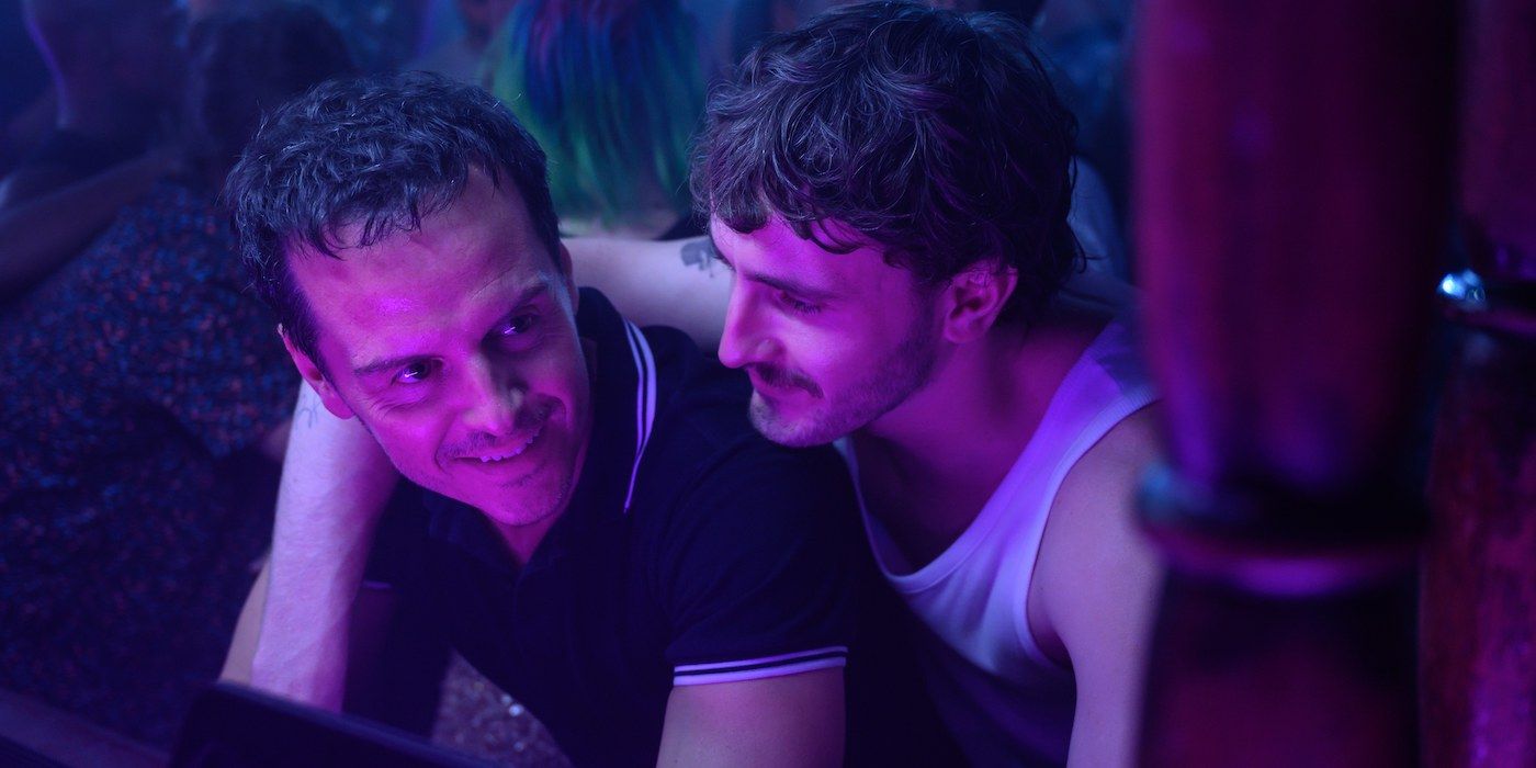 Andrew Scott and Pail Mescal as Adam and Harry embracing and smiling at a club in All of Us Strangers