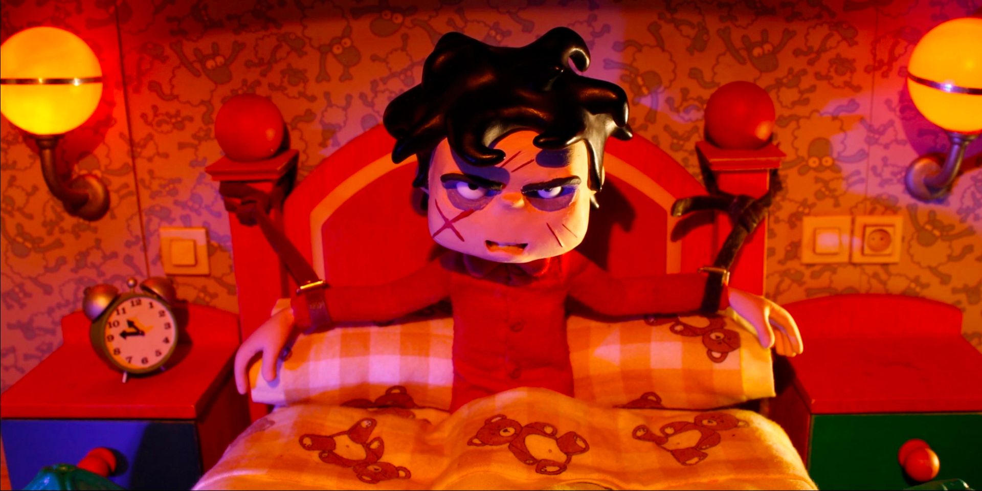 A young boy with a scratched face sits in his colourful room, strapped to the bed.