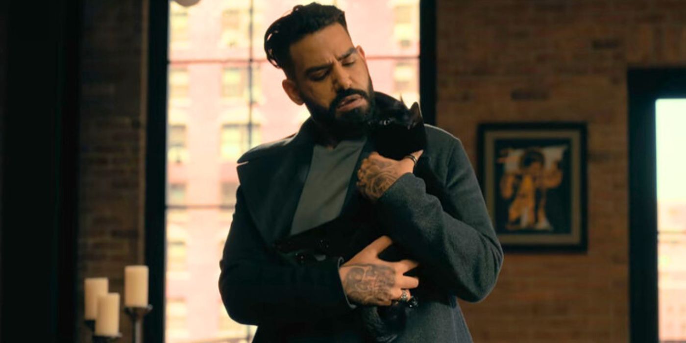 Rahul Kohli holding a black cat in The Fall of the House of Usher
