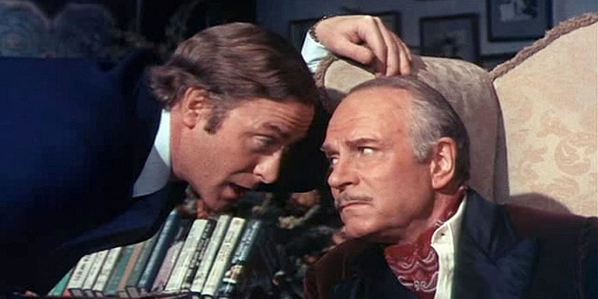 Michael Caine whispering to Laurence Olivier in Sleuth (1972).