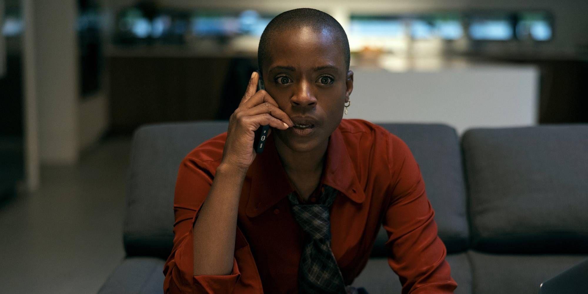 T'Nia Miller as Victorine Lafourcade with a shocked expression while holding the phone near her ear in Netflix's The Fall of the House of Usher.