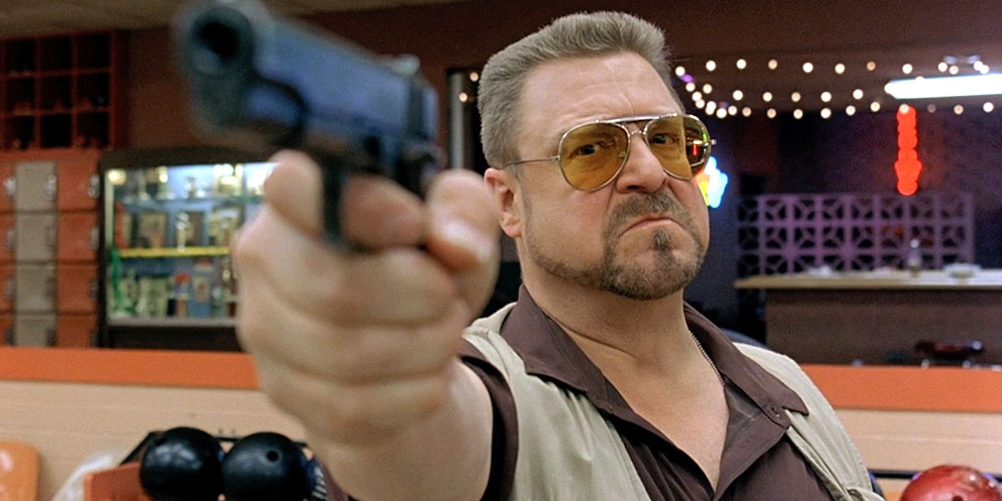 Walter pointing a gun at someone off-camera in The Big Lebowski