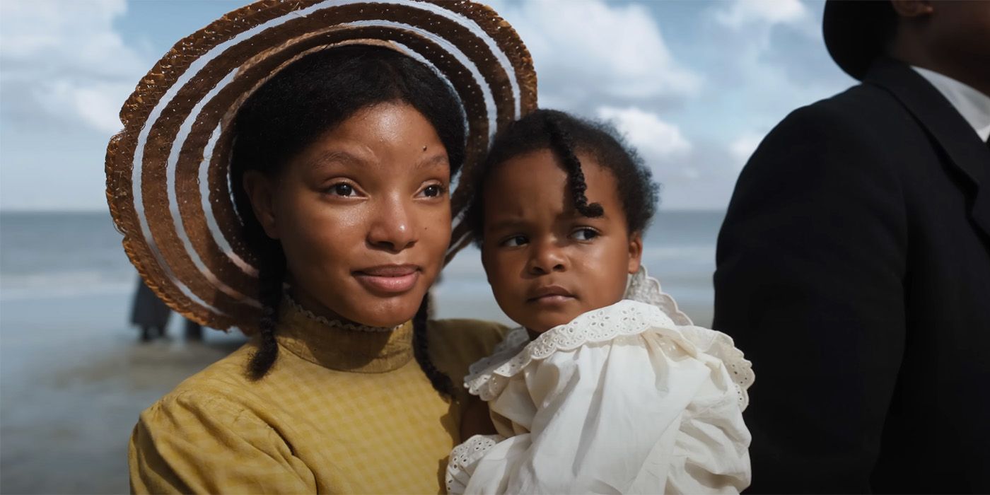 Halle Bailey as Nettie Harris carrying a baby in The Color PUrple