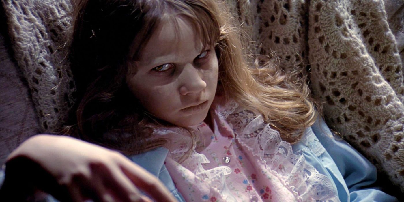 Linda Blair as a possessed Regan sitting on a chair and looking at the camera in 'The Exorcist'