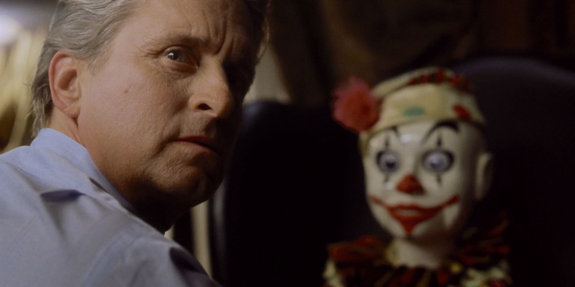 Michael Douglas as Nicholas Van Orton turning away from a toy clown in The Game