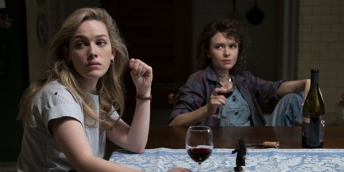 Two women drinking wine and looking in the same direction in the-haunting-of-bly-manor 