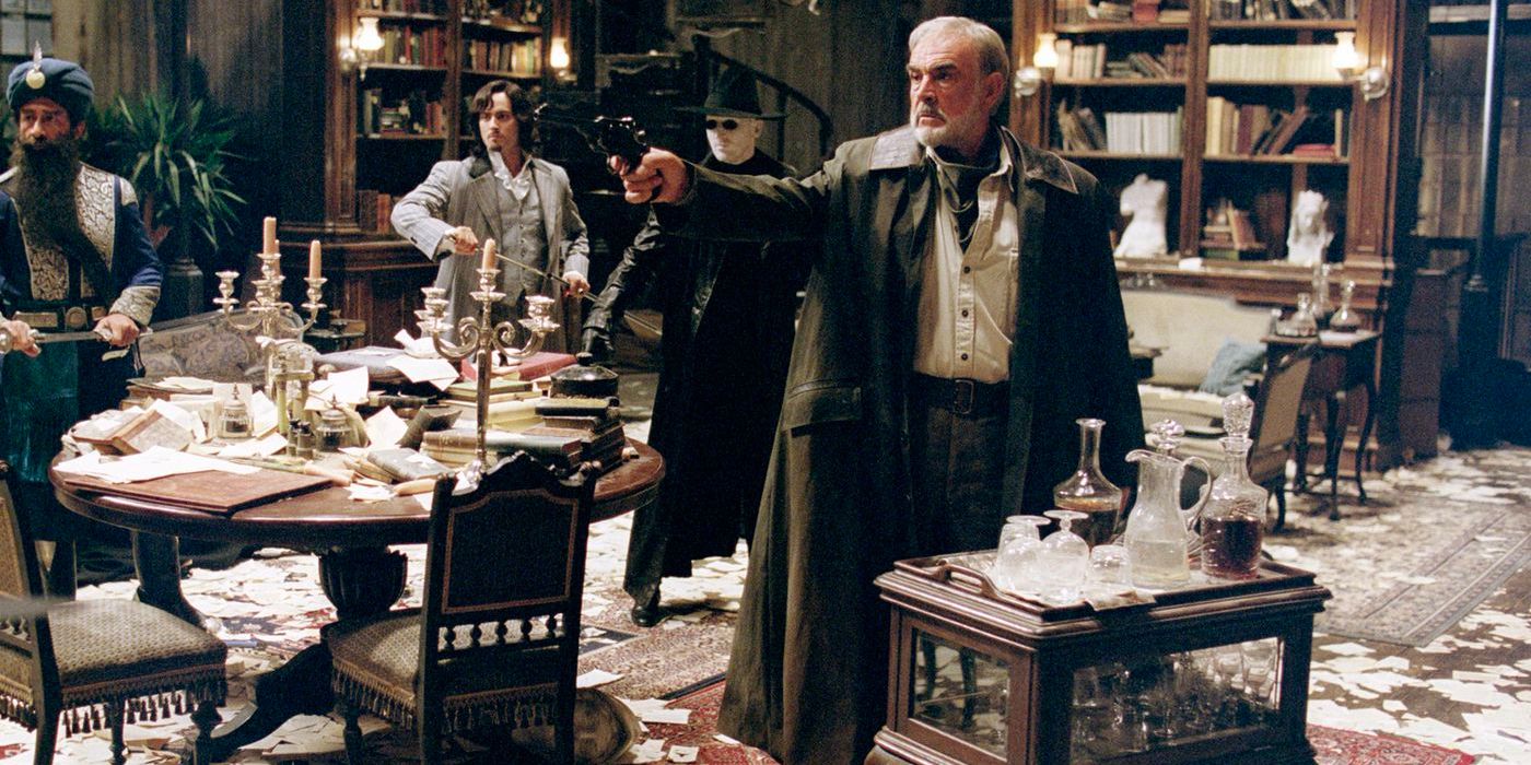 Allan Quartmain aims a revolver as he stands by the bar in a messy library room.