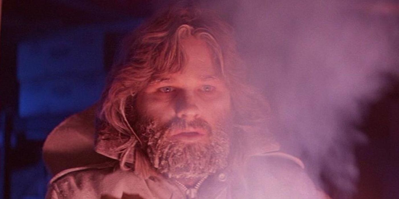 Kurt Russel as R.J. MacReady covered in snow and looking intently off-camera in The Thing