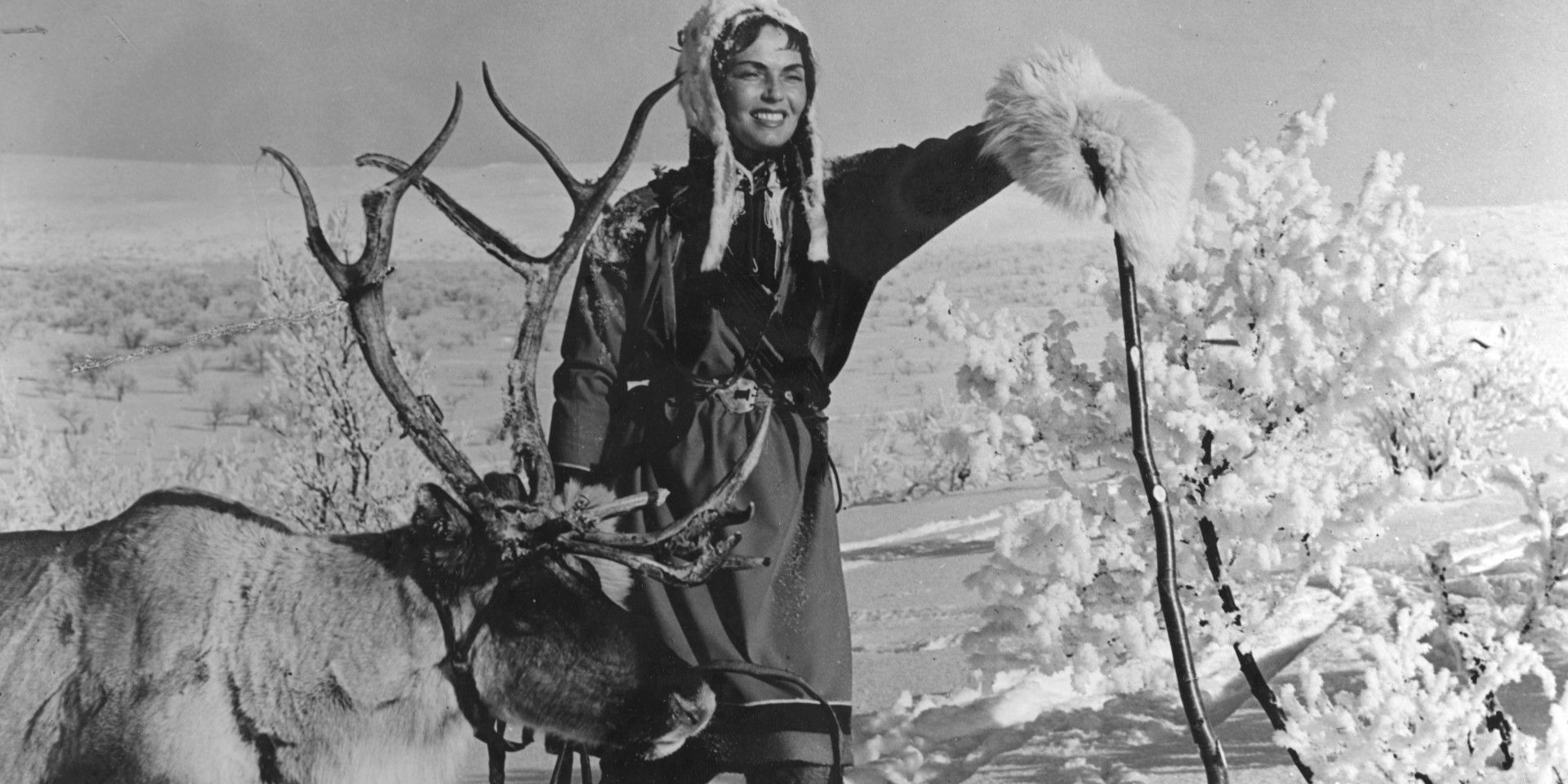 A woman walking with a reindeer in The White Reindeer.