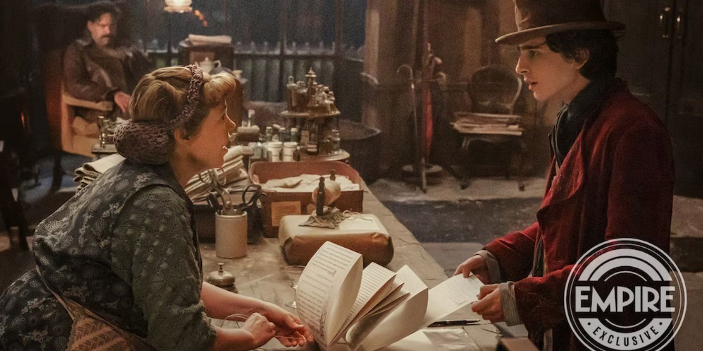 Willy Wonka and Mrs. Scrubbit, played by Timothee Chalamet and Olivia Colman, talk over a large piece of paper in star in Paul Kings Wonka