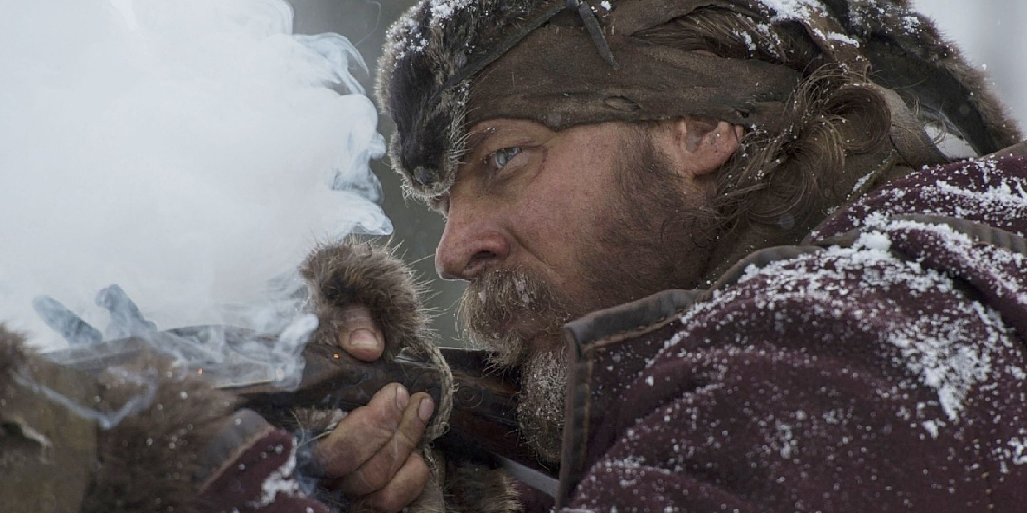 Tom Hardy as John Fitzgerald holding up a rifle  in 'The Revenant'