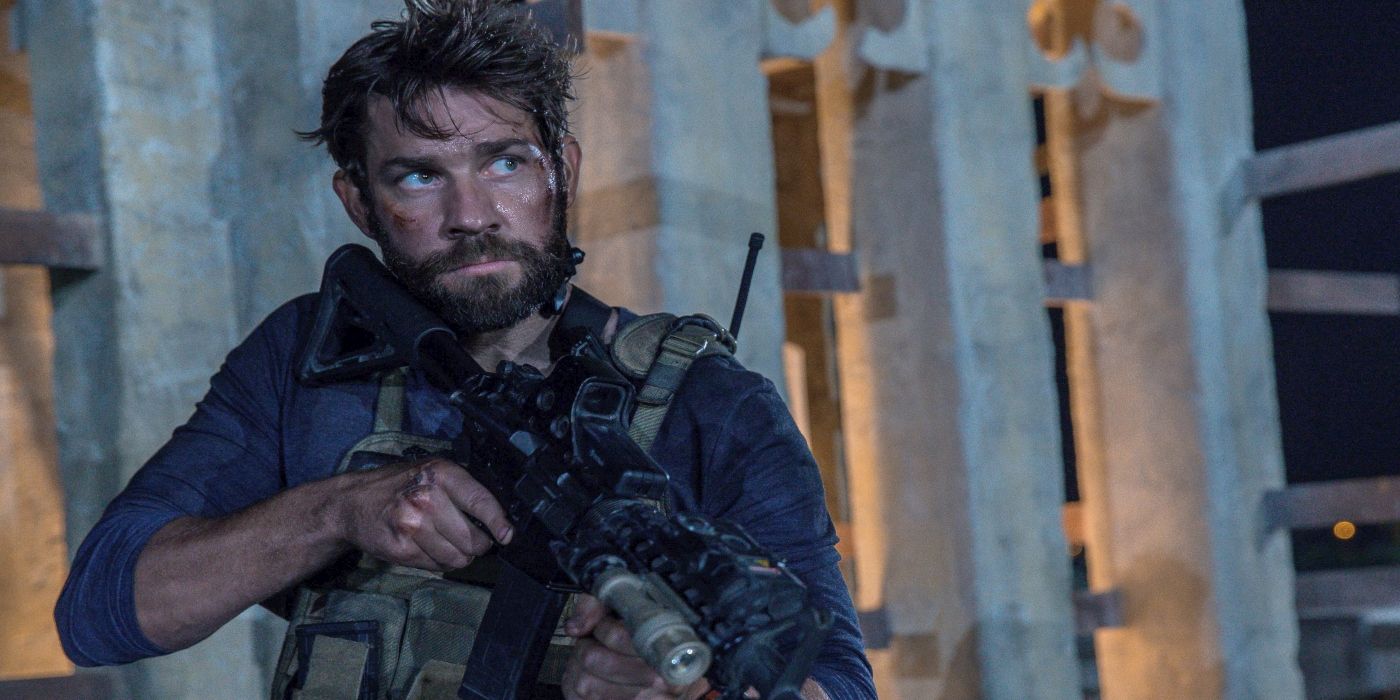 John Krasinski dirty and holding a gun in 13 Hours