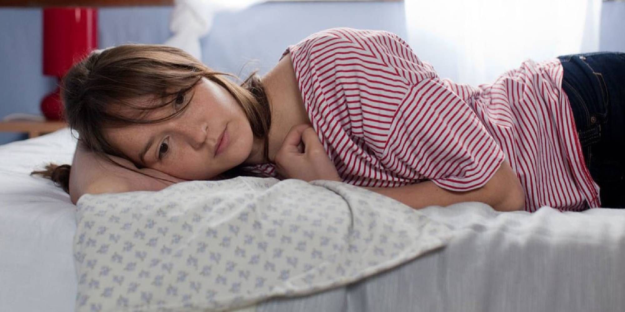 Anaïs Demoustier lying on the bed in Pauline.