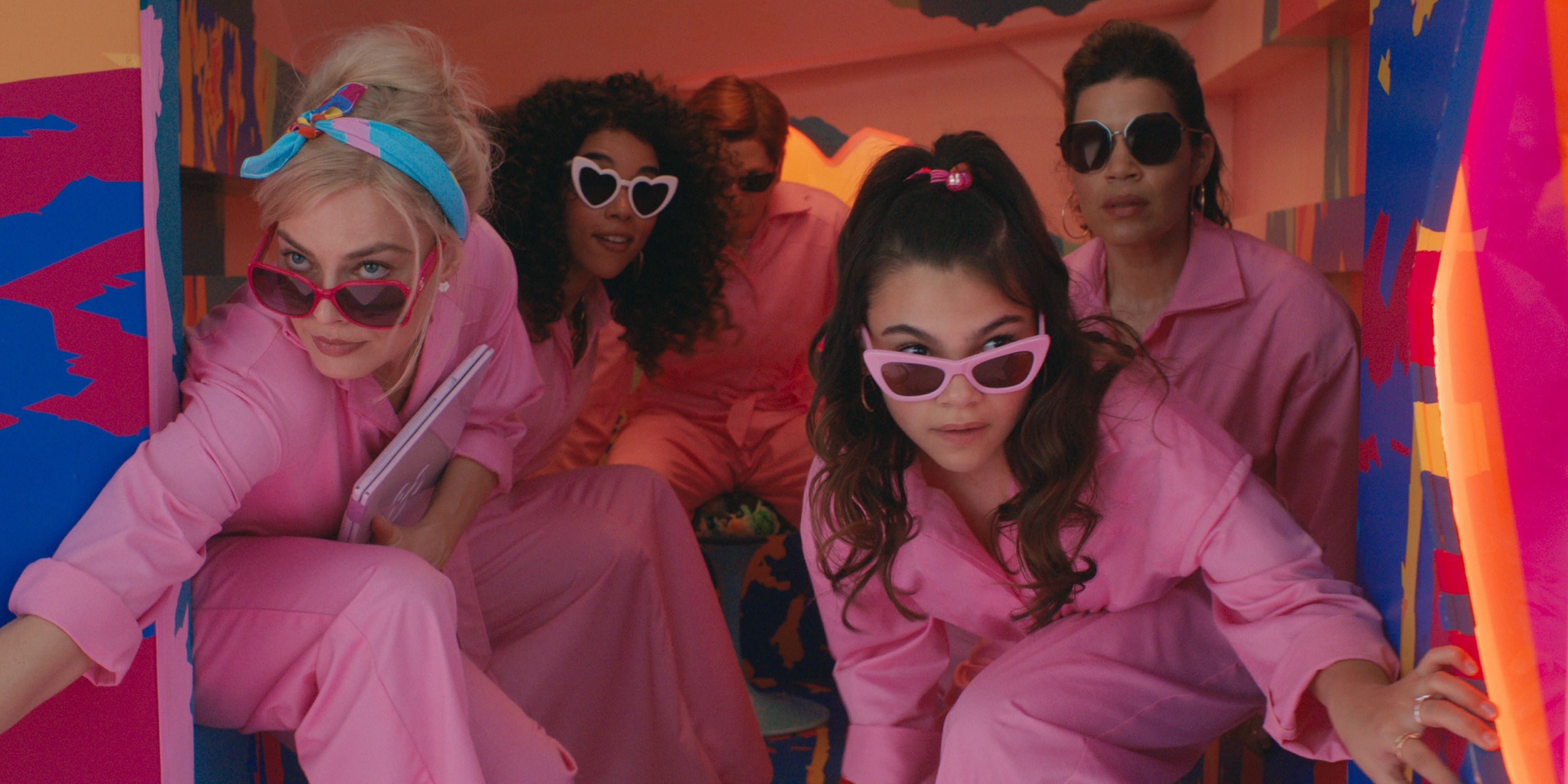 Margot Robbie and Ariana Greenblatt as Barbie and Sasha exiting a van in pink jumpsuits in Barbie
