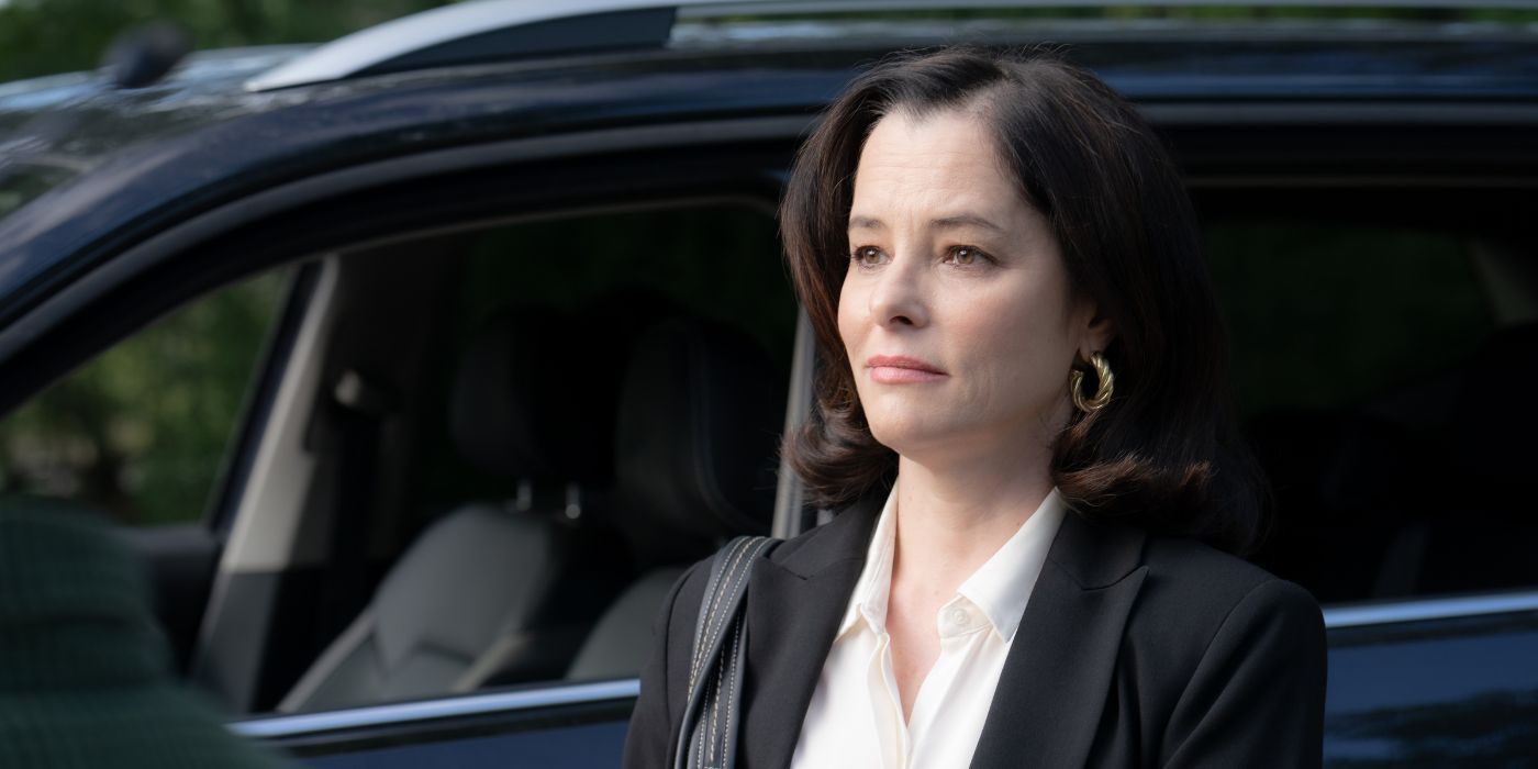Parker Posey as Elaine Bray standing by a car in Beau Is Afraid