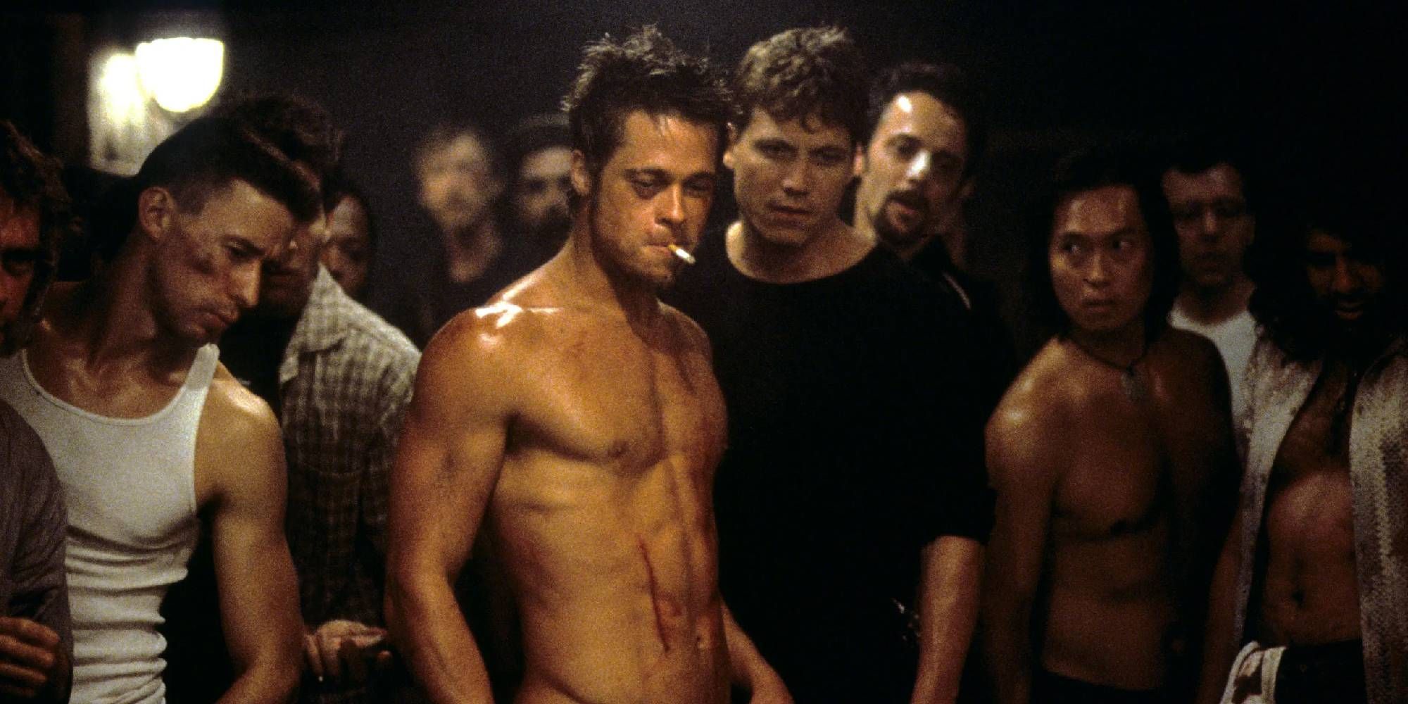 A shirtless Brad Pitt as Tyler Durden, surrounded by men in Fight Club