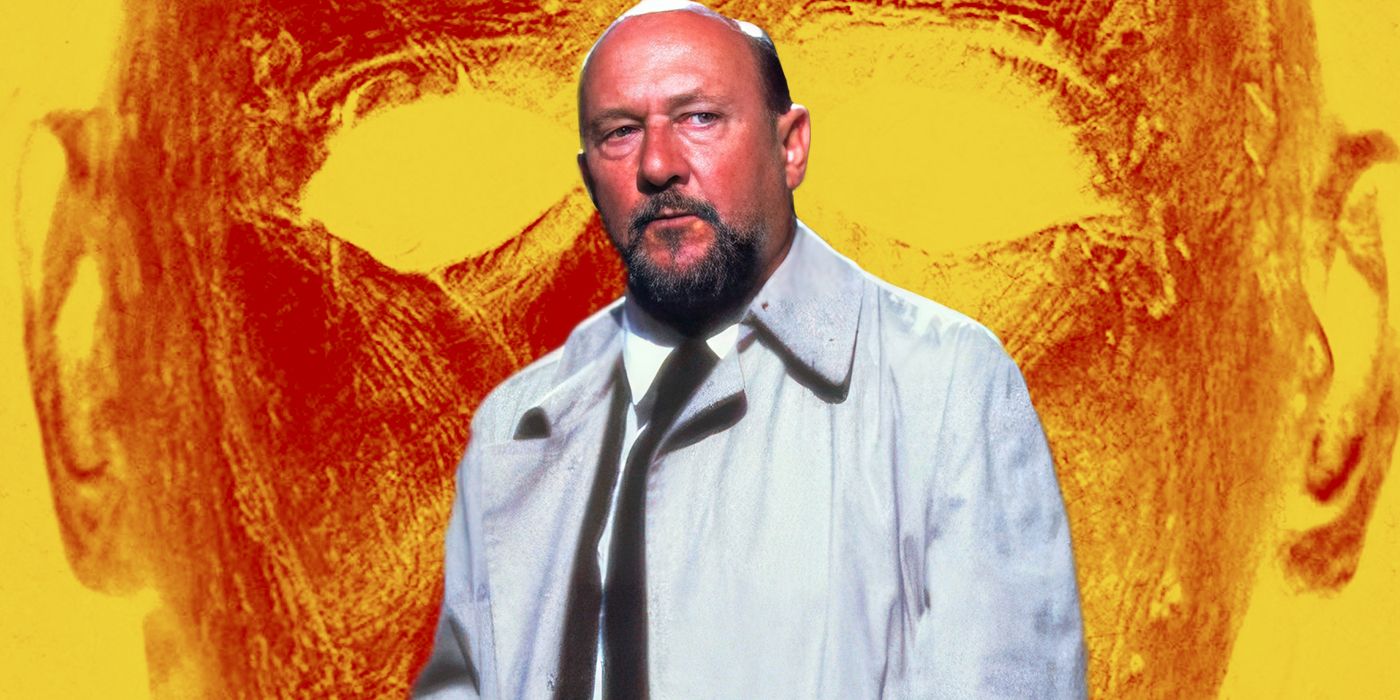 Donald Pleasence, who played Dr. Loomis in the Halloween films, stands in front of a large pumpkin colored version of Michael Myers's mask
