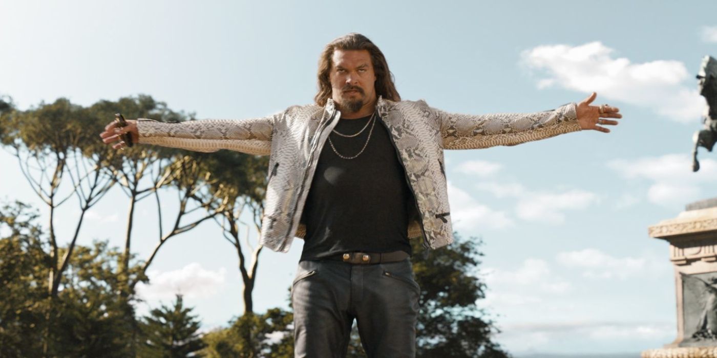Jason Mamoa as Dante wearing a snakeskin shirt with his arms raised horizontally in Fast X