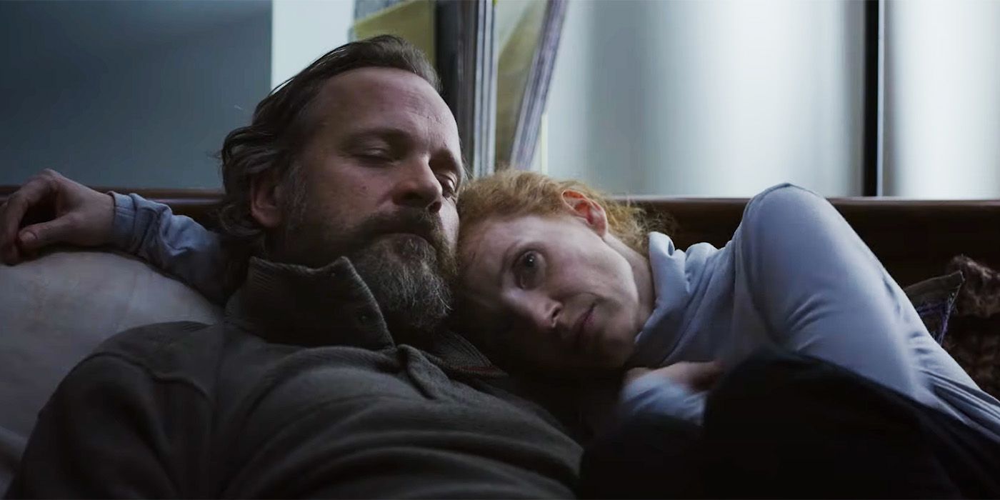 Jessica Chastain and Peter Saarsgard snuggling on a couch in Memory
