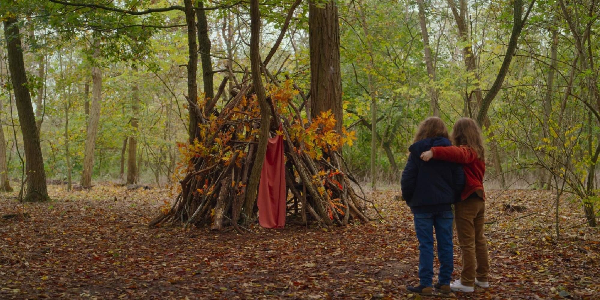 Josephine and Gabrielle Sanz looking at a forest tent in Petite Maman.