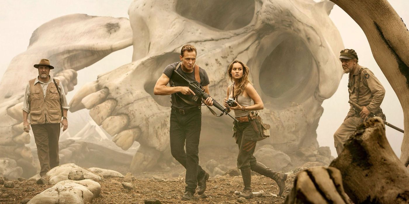 Tom Hiddleston and Brie Larson in front of a giant skull in Kong: Skull Island