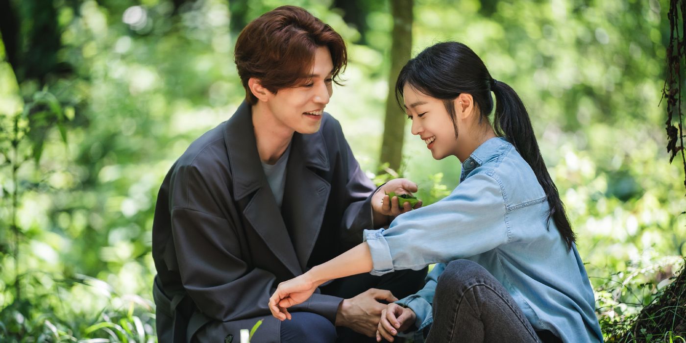 Lee Dong-wook as Lee yeon and Jo Bo-ah as Nam Ji-ah laughing in a forest in the K-Drama Tale of the Nine-Tailed