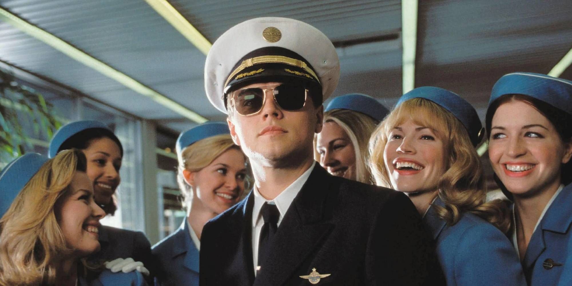 Leonardo DiCaprio as Frank Abagnale Jr. dressed as a pilot surrounded by air hostesses in Catch Me if You Can