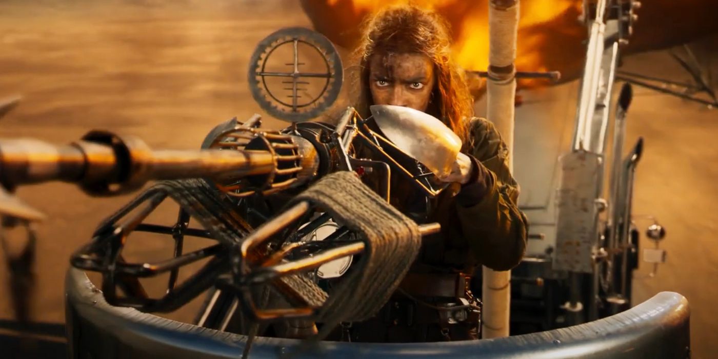 Anya Taylor-Joy as Imperator Furiosa wielding a rotary cannon gun atop a moving tank