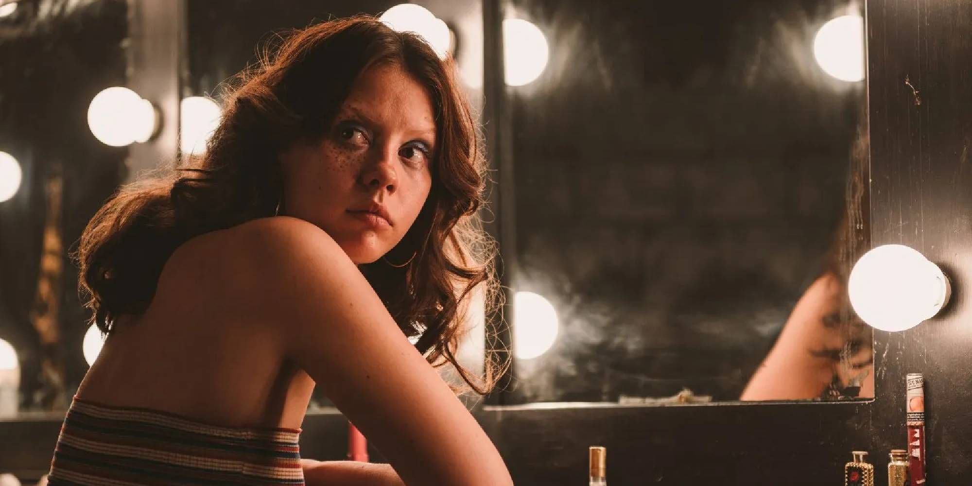 A shot of Mia Goth as Maxine sitting in front of a mirror in X.