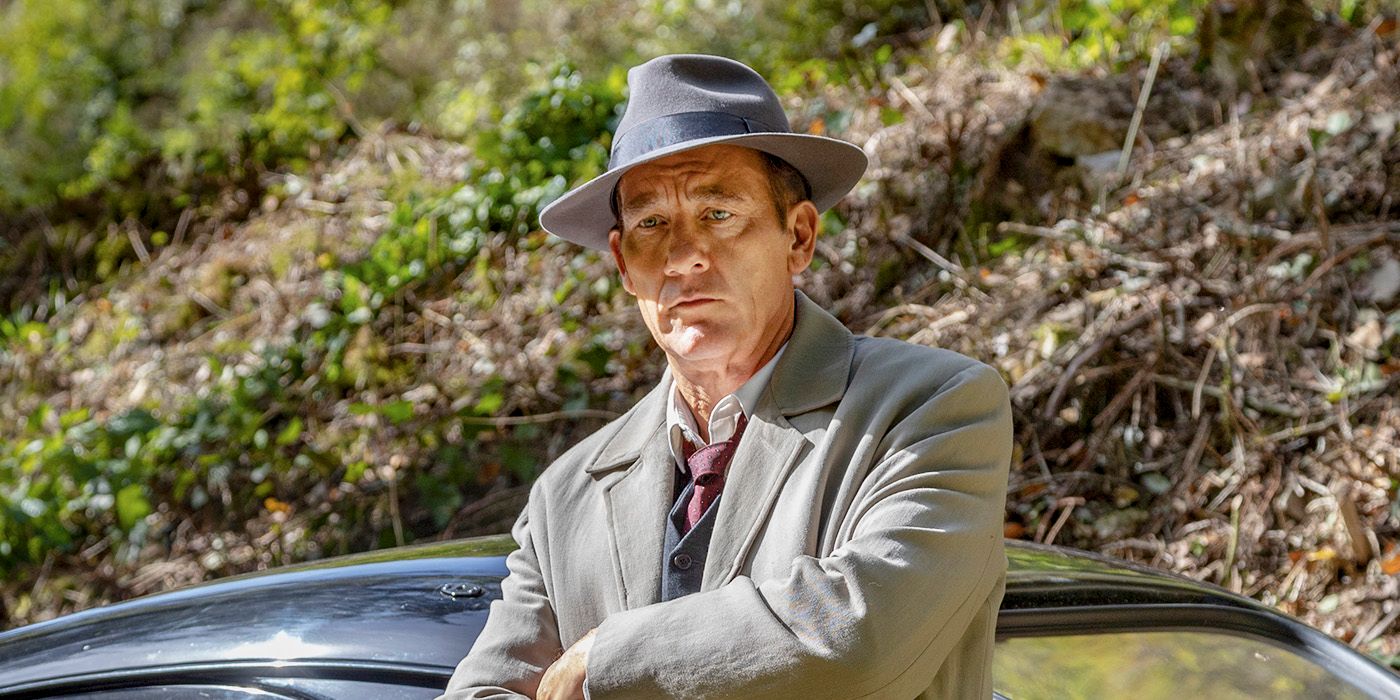 Clive Owen as Sam Spade In Monsieur Spade leaning against a car wearing a fedora