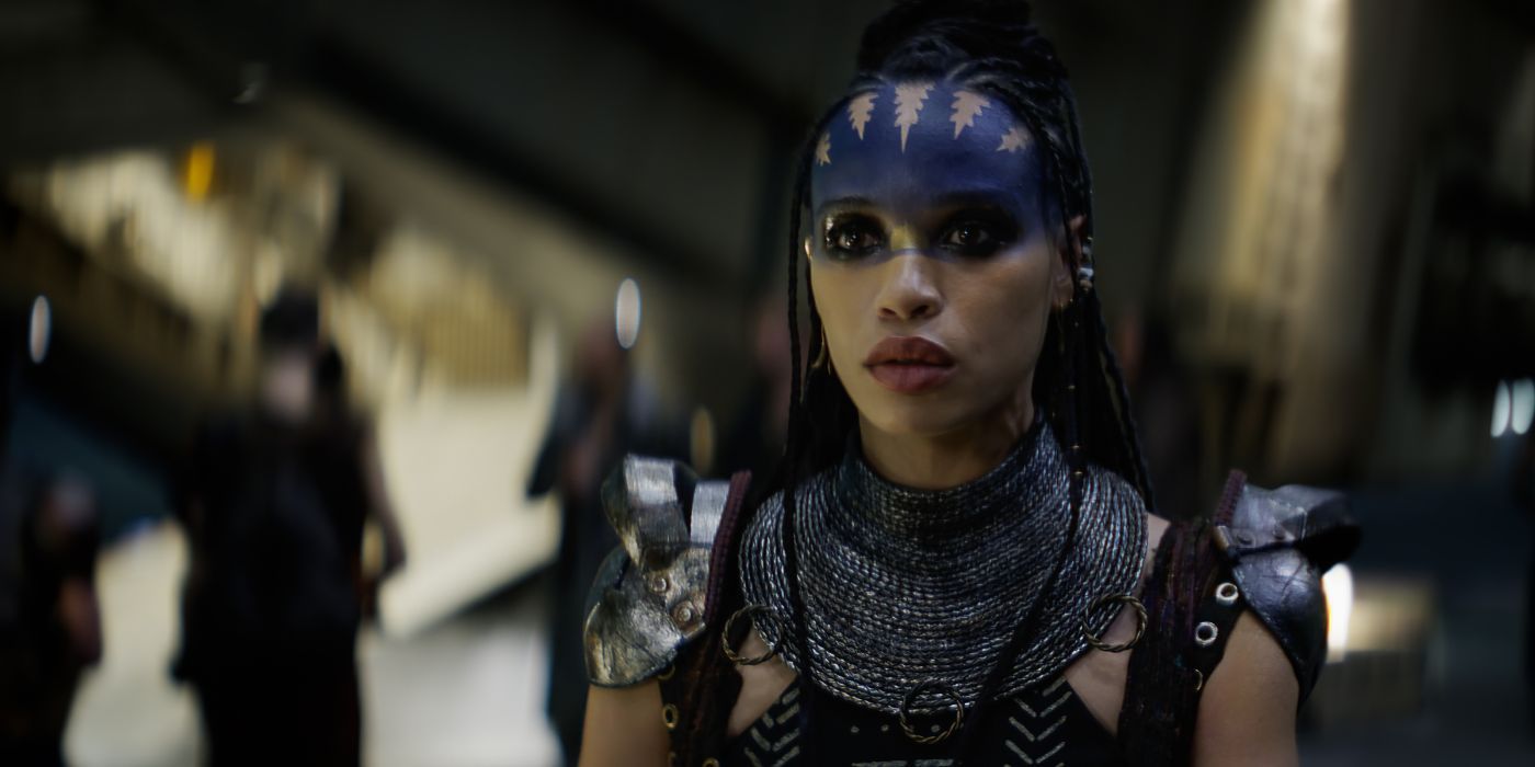 Celeopatra Coleman as Devra Bloodaxe in Rebel Moon with blue makeup on her forehead and armor of some kind on her shoulders