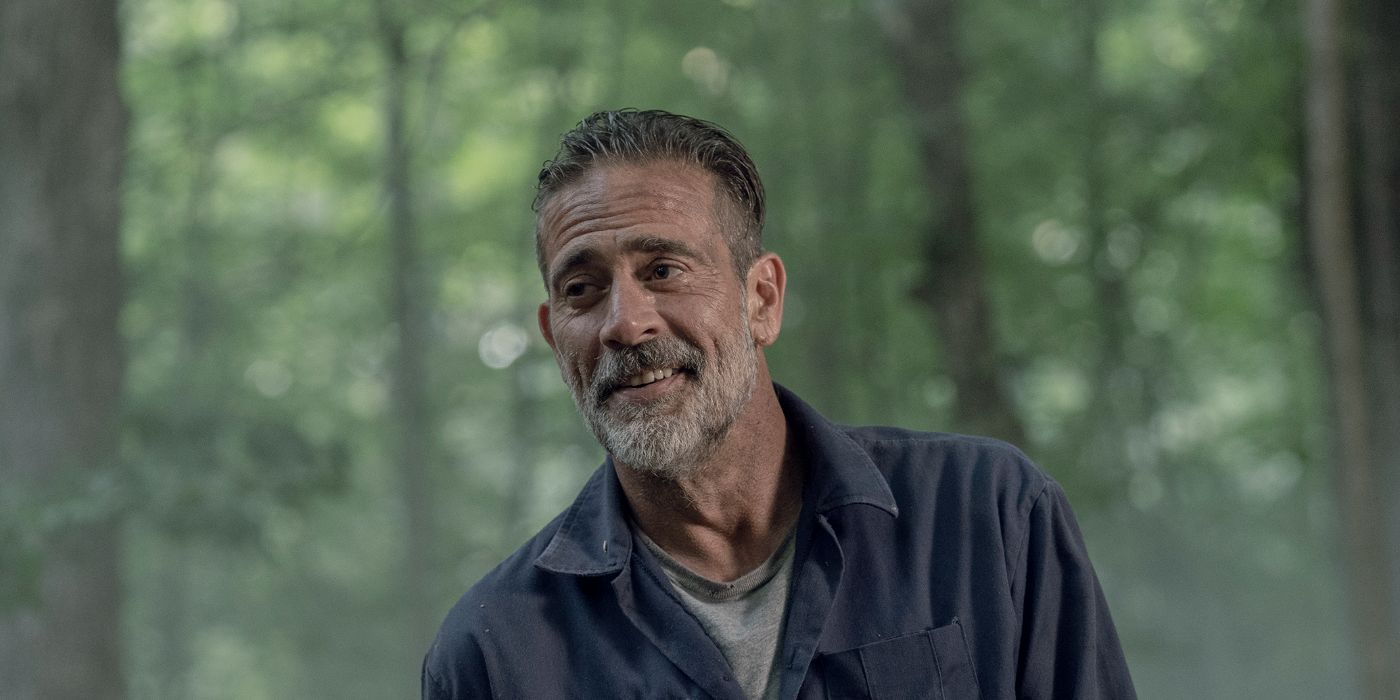 Jeffrey Dean Morgan as Negan smiling while standing in the woods in The Walking Dead