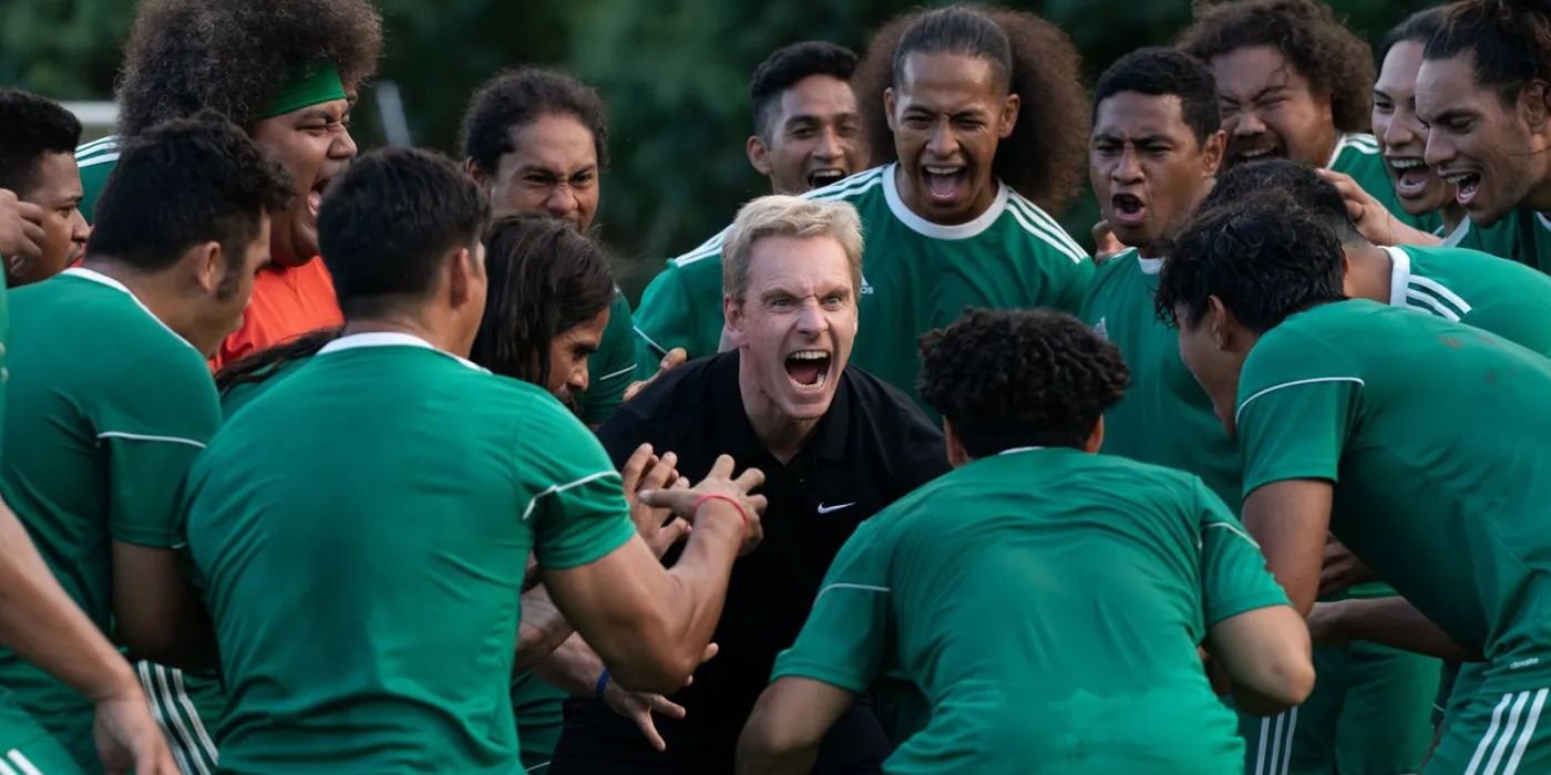 Coach Rongen, played by Michael Fassbender, surrounded by the American Samoan team in Next Goal Wins