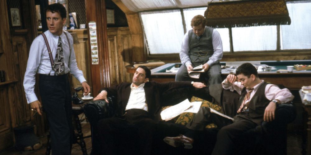 Noodles, played by Robert De Niro, sits on a couch with the gang in Once Upon a Time in America
