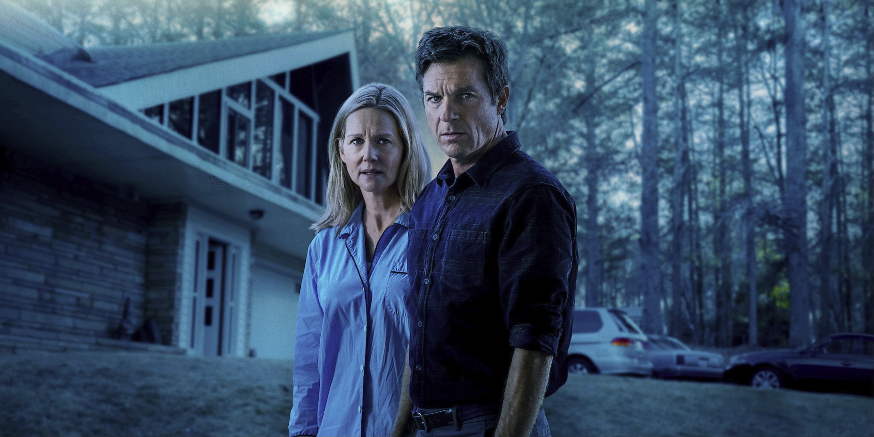 Jason Bateman as Marty Byrde and Laura Linney as Wendy Byrde standing in front of a house on the show Ozark