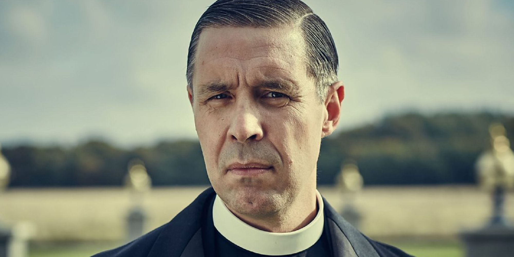 A close-up shot of Patrick Jarvis MP as Father Hughes in Peaky Blinders.