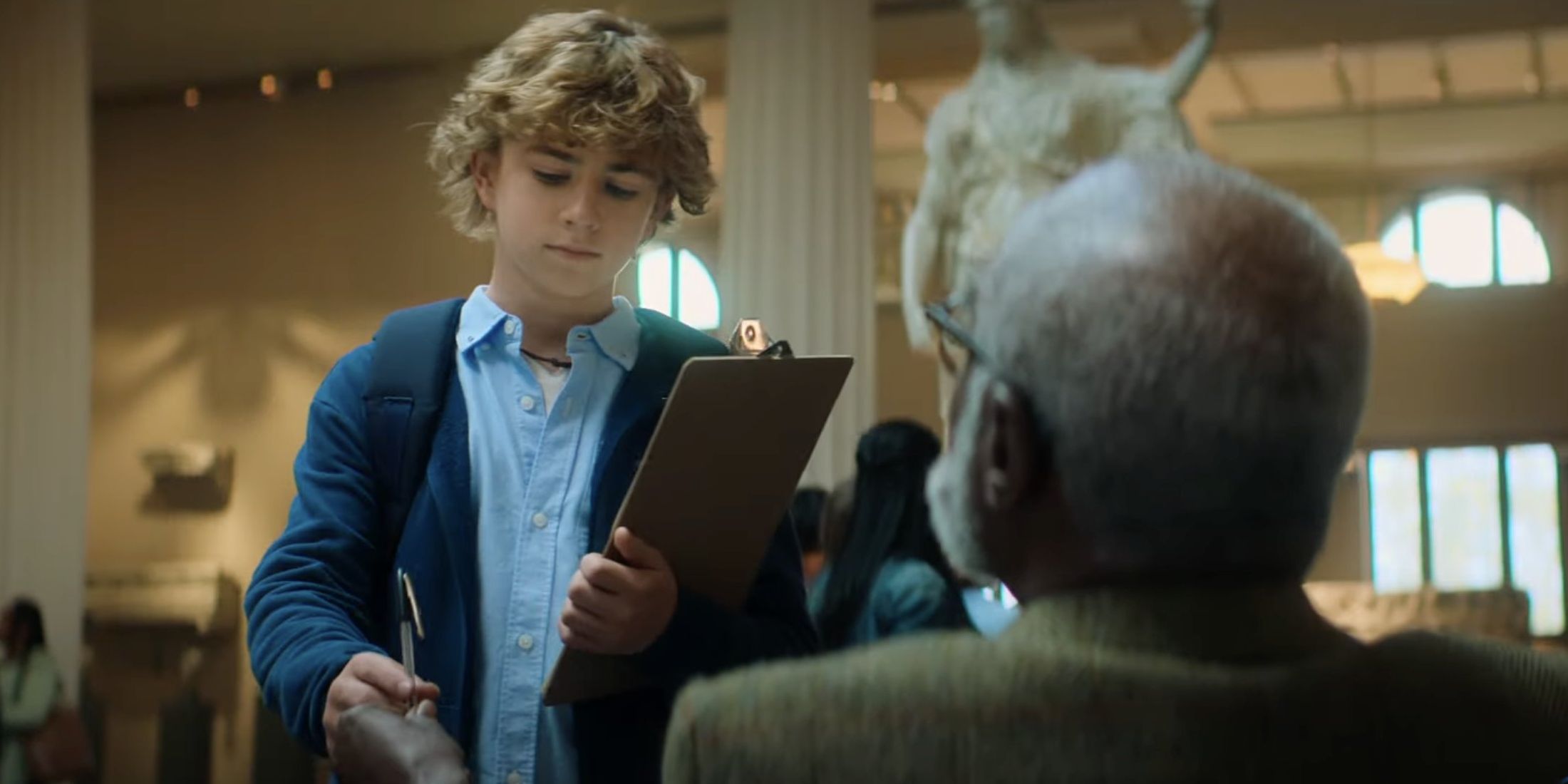 Percy (Walker Scobell) getting a pen from Chiron (Glynn Turman) in 'Percy Jackson and the Olympians'
