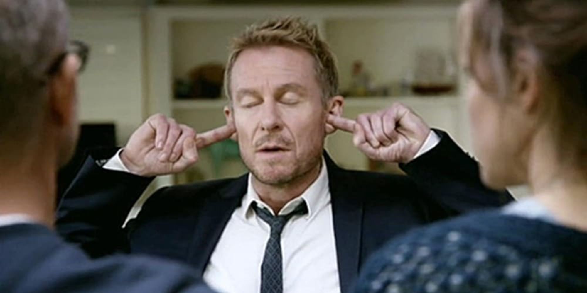 Richard Roxburgh as Cleaver Greene plugging his ears with his eyes closed in the show Rake