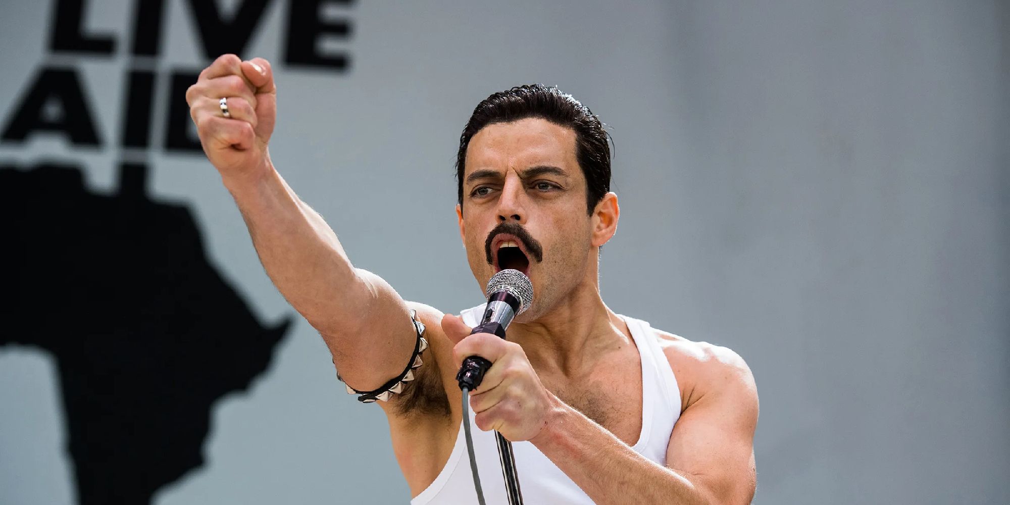 Rami Malek as Freddy Mercury singing live in Bohemian Rhapsody.