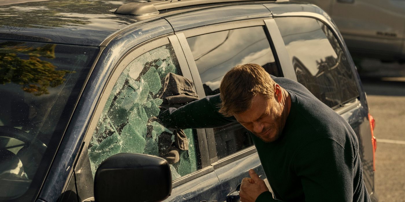Jack Reacher (Alan Ritchson) breaking a car window in Reacher Season 2