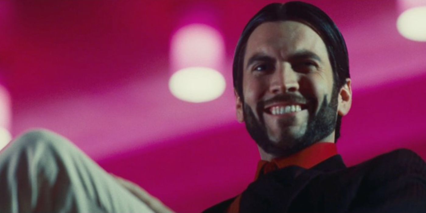 Seneca Crane smiling widely in The Hunger Games